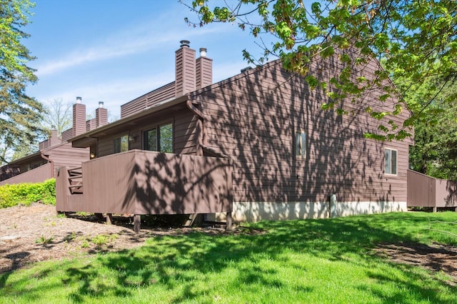 131 E Jolly Rd Unit E6, Lansing, MI 48910 - view of side of home with a lawn and a chimney