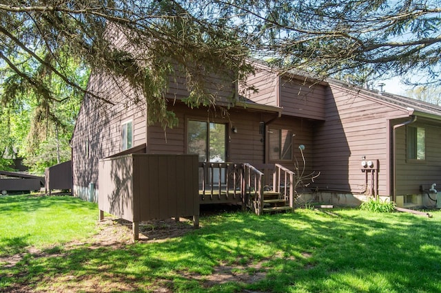 131 E Jolly Rd Unit E6, Lansing, MI 48910 - back of house with a deck and a yard