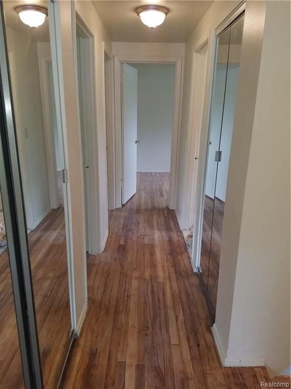 hall with wood finished floors