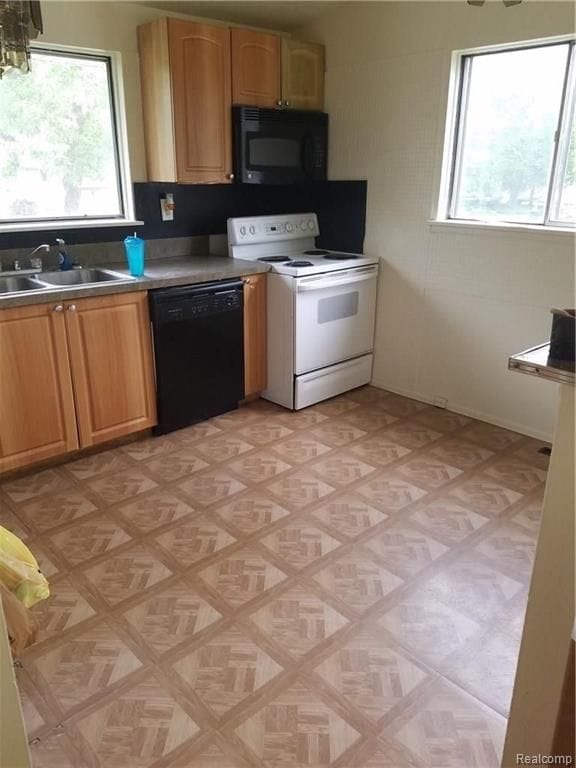 kitchen featuring a sink and black appliances