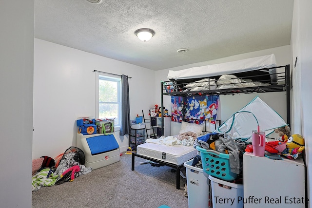 bedroom featuring carpet and a textured ceiling
