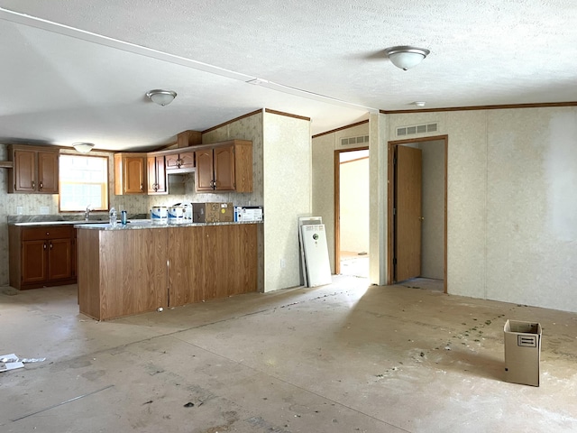 3947 W Jefferson Ave, Trenton, MI 48183 - kitchen featuring visible vents, brown cabinets, and a textured ceiling