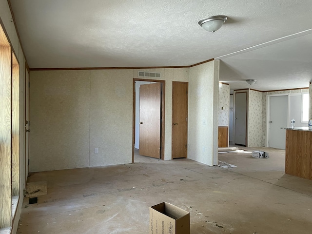 3947 W Jefferson Ave, Trenton, MI 48183 - unfurnished room featuring visible vents, a textured ceiling, and ornamental molding