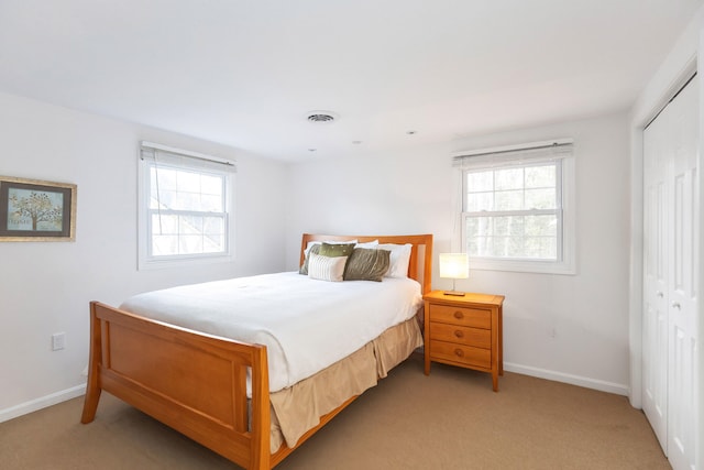 9696 Union Pier Rd, Union Pier, MI 49129 - bedroom featuring a closet, visible vents, light colored carpet, and baseboards