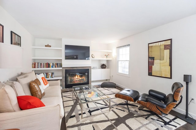 9696 Union Pier Rd, Union Pier, MI 49129 - living area featuring built in features, a fireplace, baseboards, and wood finished floors