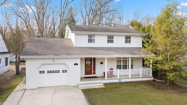 9696 Union Pier Rd, Union Pier, MI 49129 - traditional home featuring a front yard, driveway, covered porch, a shingled roof, and a garage