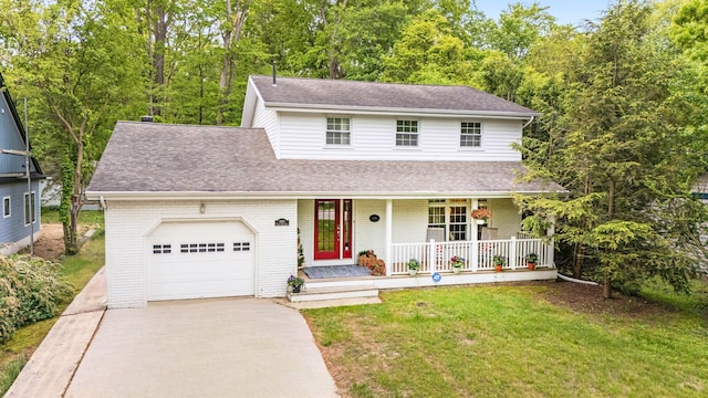9696 Union Pier Rd, Union Pier, MI 49129 - traditional home featuring covered porch, a garage, driveway, a front yard, and brick siding