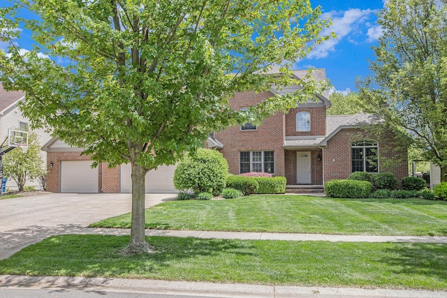 6317 Wilson Rd, Ann Arbor, MI 48108 - view of front of home featuring brick siding, concrete driveway, a front yard, and a garage