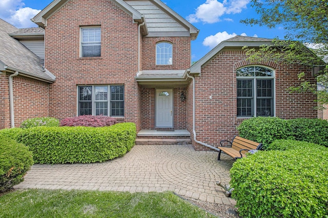 6317 Wilson Rd, Ann Arbor, MI 48108 - view of front facade featuring brick siding and a patio