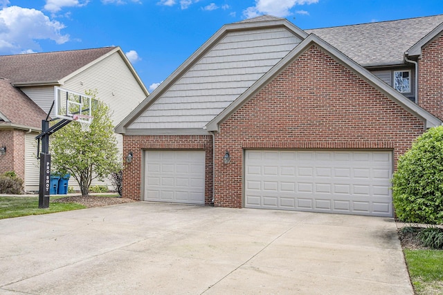 6317 Wilson Rd, Ann Arbor, MI 48108 - view of property exterior featuring brick siding, concrete driveway, and an attached garage