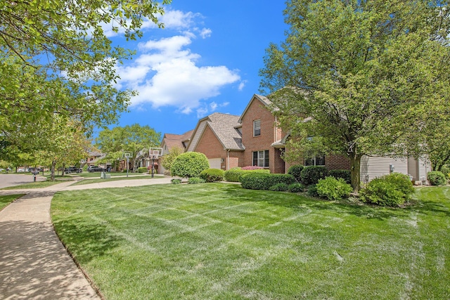 6317 Wilson Rd, Ann Arbor, MI 48108 - view of front facade with brick siding and a front lawn
