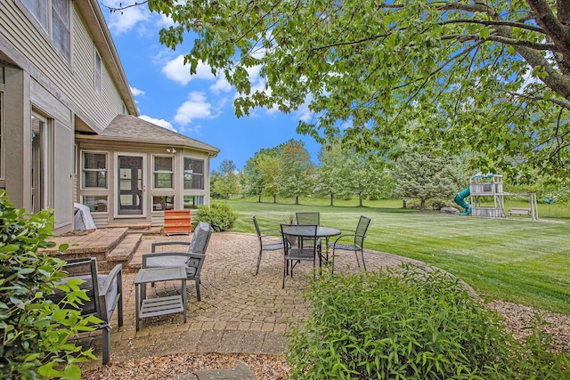 6317 Wilson Rd, Ann Arbor, MI 48108 - view of patio featuring a playground and outdoor dining space
