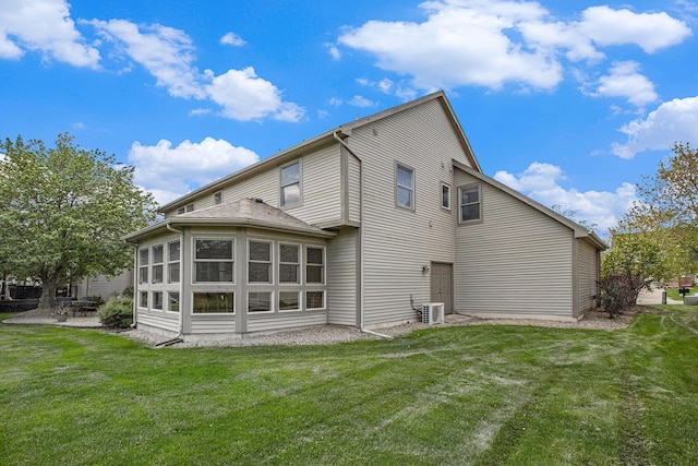 6317 Wilson Rd, Ann Arbor, MI 48108 - back of property with cooling unit, a yard, and a patio