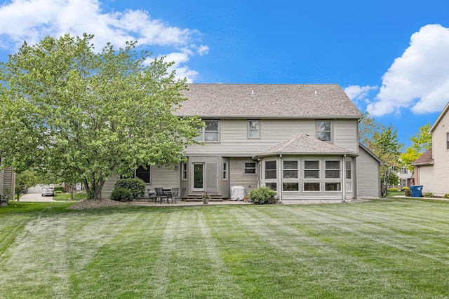 6317 Wilson Rd, Ann Arbor, MI 48108 - back of property featuring entry steps, a yard, a patio, and a shingled roof