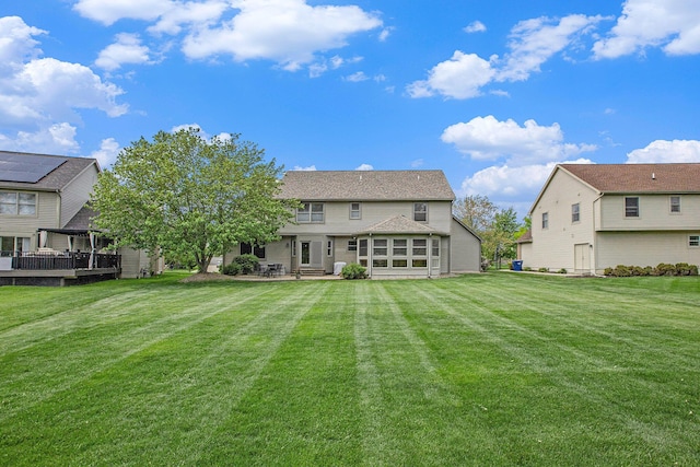 6317 Wilson Rd, Ann Arbor, MI 48108 - back of house featuring a lawn and a patio