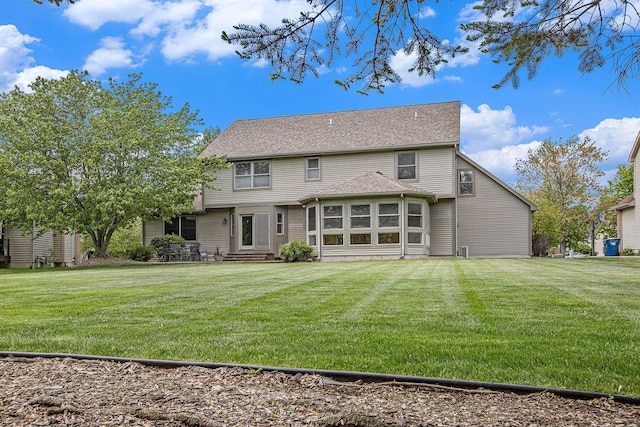 6317 Wilson Rd, Ann Arbor, MI 48108 - back of house featuring entry steps and a lawn