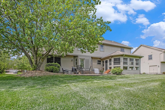 6317 Wilson Rd, Ann Arbor, MI 48108 - rear view of house featuring a sunroom, a lawn, and entry steps