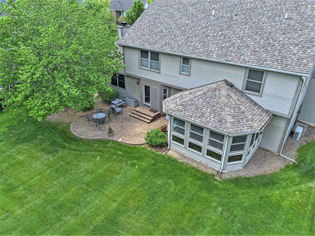 6317 Wilson Rd, Ann Arbor, MI 48108 - rear view of house featuring a shingled roof, a patio, and a yard