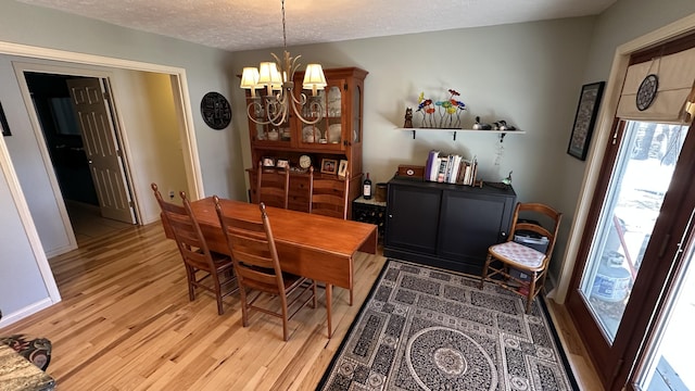 70255 51st St, Lawrence, MI 49064 - dining space with a textured ceiling, a wealth of natural light, light wood-style flooring, and a notable chandelier