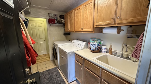 70255 51st St, Lawrence, MI 49064 - washroom with a sink, light tile patterned flooring, cabinet space, and washing machine and clothes dryer