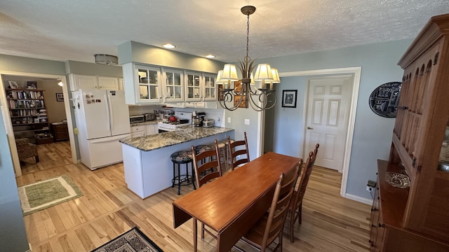 70255 51st St, Lawrence, MI 49064 - dining area featuring recessed lighting, a textured ceiling, a notable chandelier, and light wood finished floors
