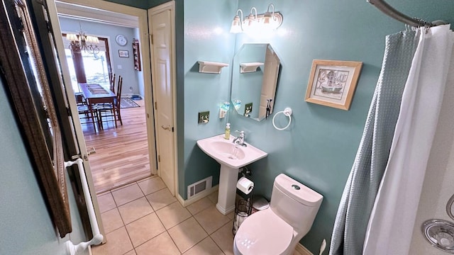 70255 51st St, Lawrence, MI 49064 - full bathroom with a notable chandelier, toilet, tile patterned floors, baseboards, and visible vents