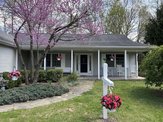 70255 51st St, Lawrence, MI 49064 - view of front facade featuring roof with shingles, a porch, and a front lawn