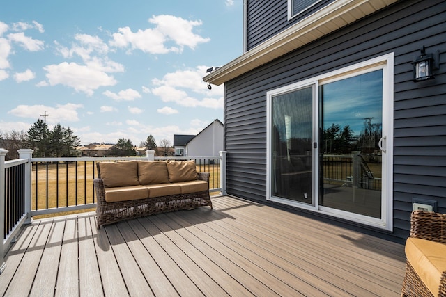 wooden terrace with an outdoor living space