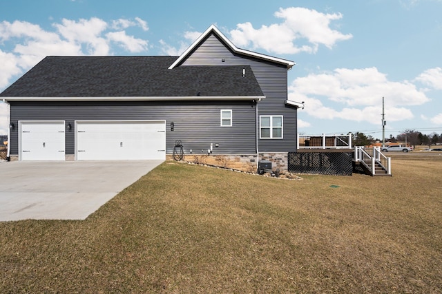 view of home's exterior featuring a yard, driveway, a wooden deck, and a garage
