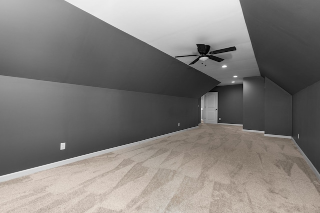 additional living space with ceiling fan, light carpet, recessed lighting, baseboards, and vaulted ceiling