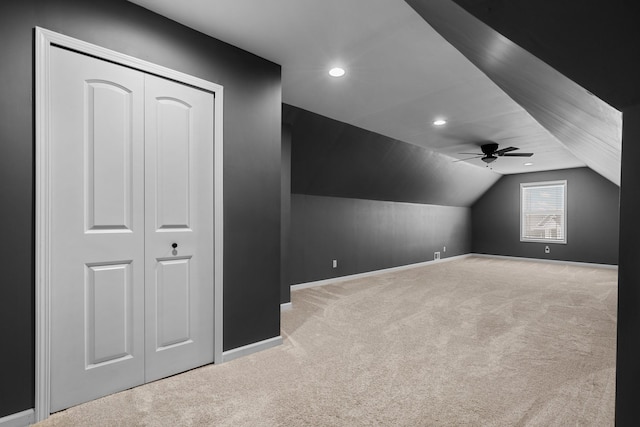 additional living space featuring carpet, a ceiling fan, baseboards, recessed lighting, and lofted ceiling