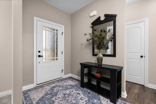 entrance foyer with baseboards and wood finished floors