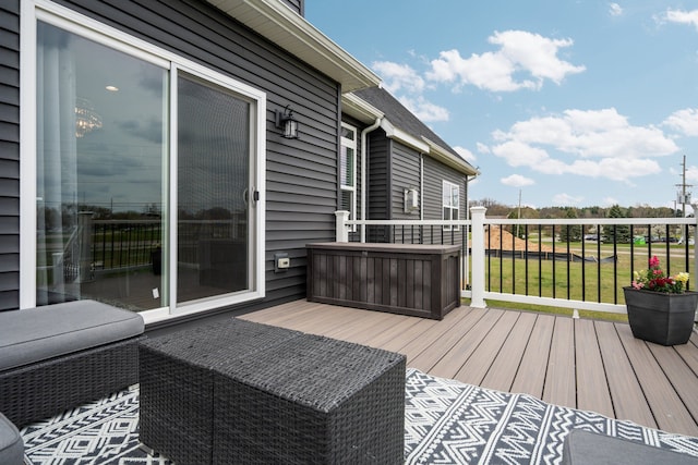 wooden deck featuring a lawn