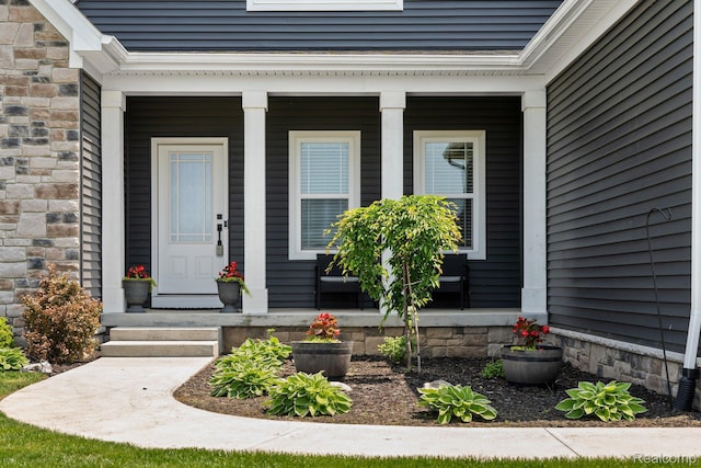 9931 Loretta Ln, South Lyon, MI 48178 - view of exterior entry featuring covered porch