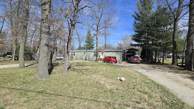 3867 Joseph St, Wellston, MI 49689 - view of front of home featuring a carport, driveway, and a front yard