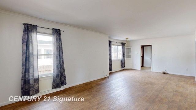 308 S Elm St, Saginaw, MI 48602 - spare room featuring crown molding, baseboards, and wood finished floors
