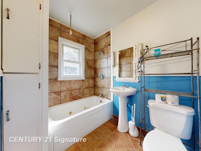 308 S Elm St, Saginaw, MI 48602 - bathroom featuring tile patterned floors, toilet, and a combined bath / shower with jetted tub