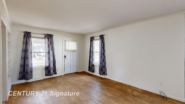 308 S Elm St, Saginaw, MI 48602 - spare room with wood finished floors, baseboards, and ornamental molding