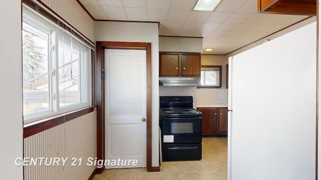 308 S Elm St, Saginaw, MI 48602 - kitchen with light floors, freestanding refrigerator, light countertops, black range with electric stovetop, and under cabinet range hood