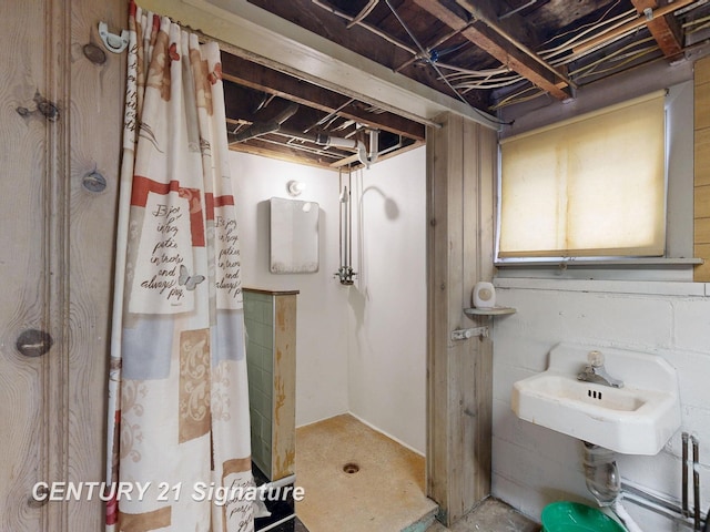 308 S Elm St, Saginaw, MI 48602 - bathroom with a shower with shower curtain and unfinished concrete flooring