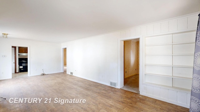 308 S Elm St, Saginaw, MI 48602 - unfurnished room featuring wood finished floors, visible vents, and baseboards