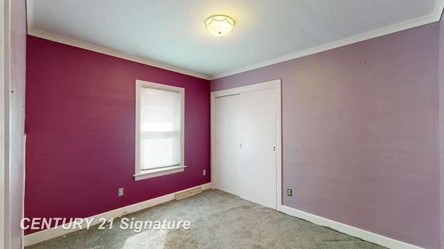 308 S Elm St, Saginaw, MI 48602 - unfurnished bedroom with visible vents, crown molding, baseboards, carpet floors, and a closet