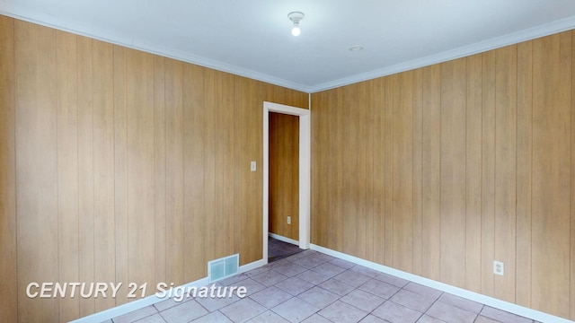 308 S Elm St, Saginaw, MI 48602 - tiled empty room with visible vents, baseboards, and ornamental molding