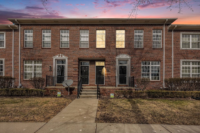 townhome / multi-family property featuring brick siding