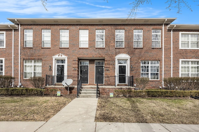 townhome / multi-family property with brick siding