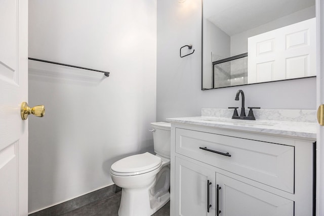 bathroom featuring tile patterned flooring, toilet, vanity, and baseboards