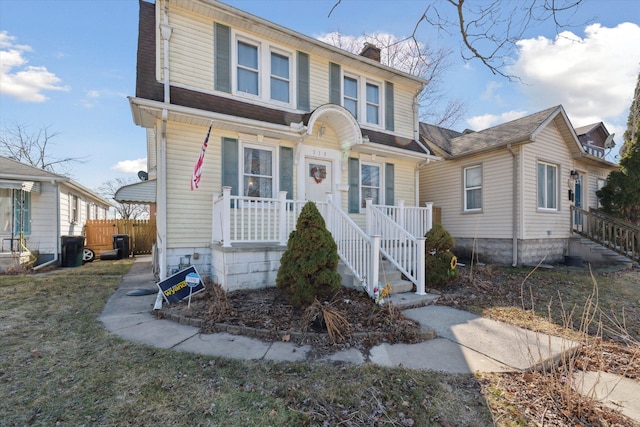 view of front of home featuring a chimney and fence