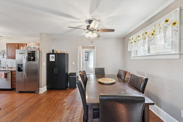 dining room with baseboards, wood finished floors, and ceiling fan