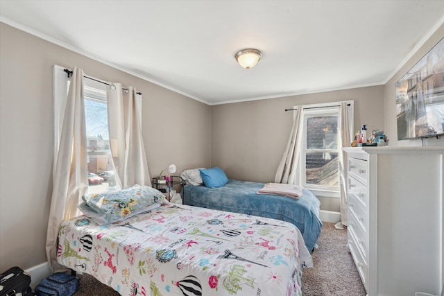 bedroom with baseboards, carpet flooring, and crown molding