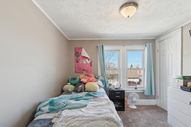 carpeted bedroom with ornamental molding and a textured ceiling